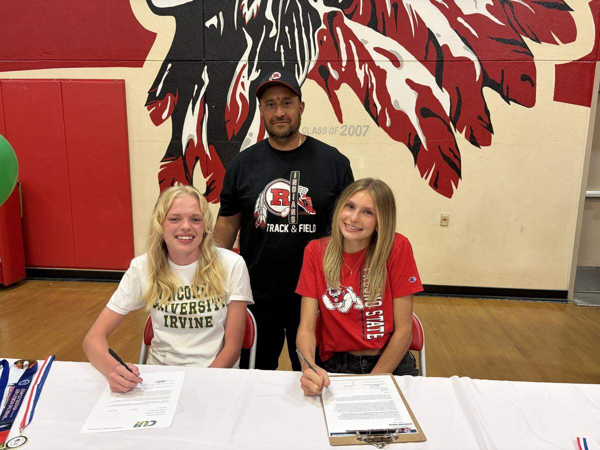 Ripon track and field teammates Clara Schoolland (Concordia University of Irvine) and Kaiya Kroutil (Fresno State University) take a picture with head track and field coach Jorge Velasco at a signing ceremony, May 20, 2026.