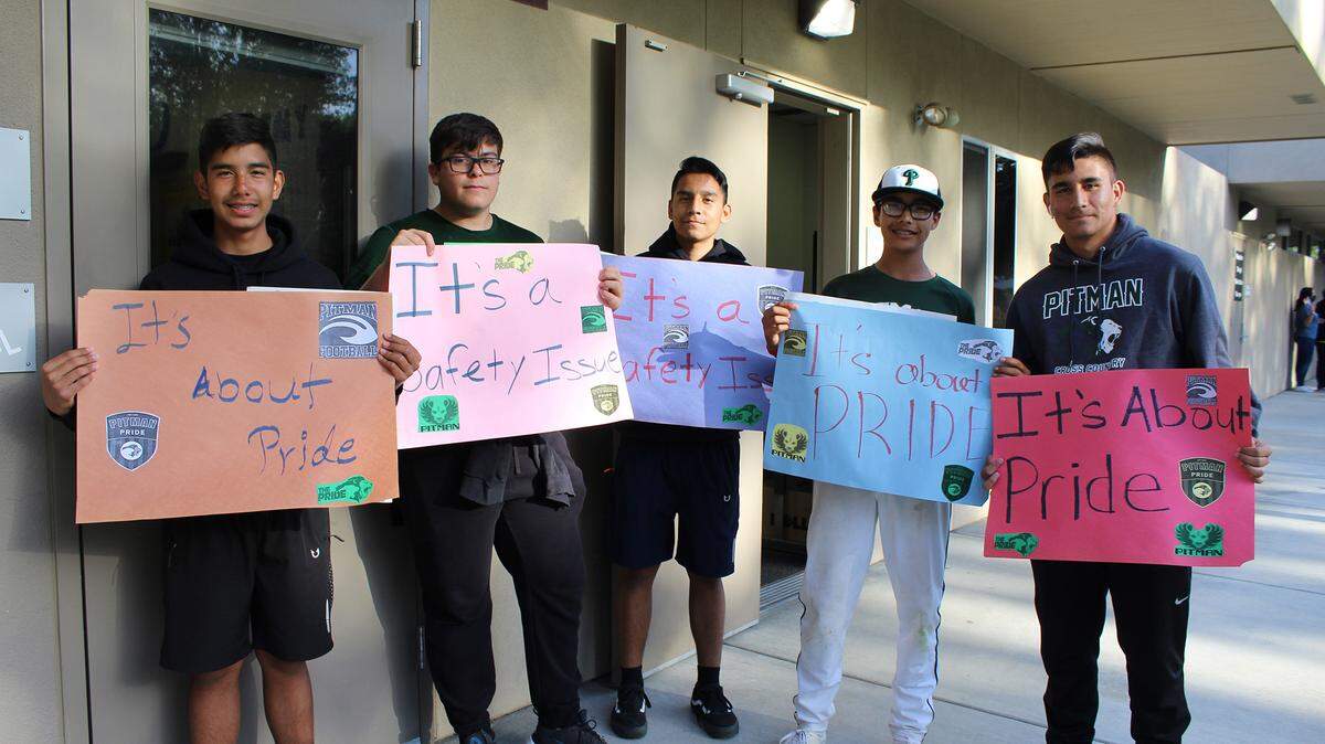 Students hold signs calling on Turlock Unified School District to complete Pitman High School’s sports facilities in Turlock, Calif. on Tuesday, April 5, 2022.