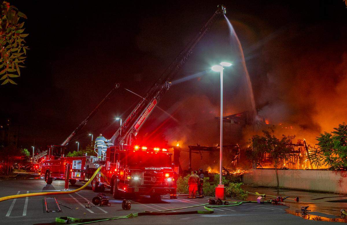 Modesto Fire Department crews battle a huge structure fire at a warehouse at the corner of Tully Road and Ninth Street on Sunday, July 7, 2019.