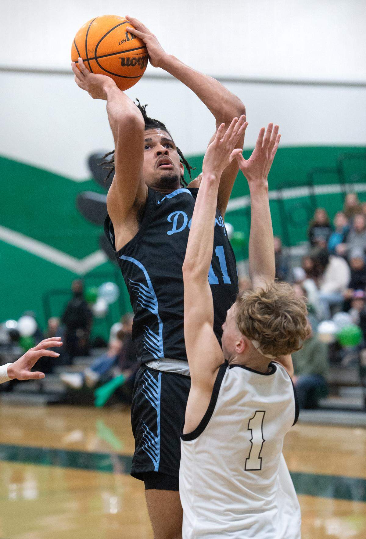 Downey’s Lloyd French scores over Pitman defender Avery Sanchez during the Central California Athletic League game in Turlock, Calif., Wednesday, Jan. 18, 2023. Downey won the game 52-44.
