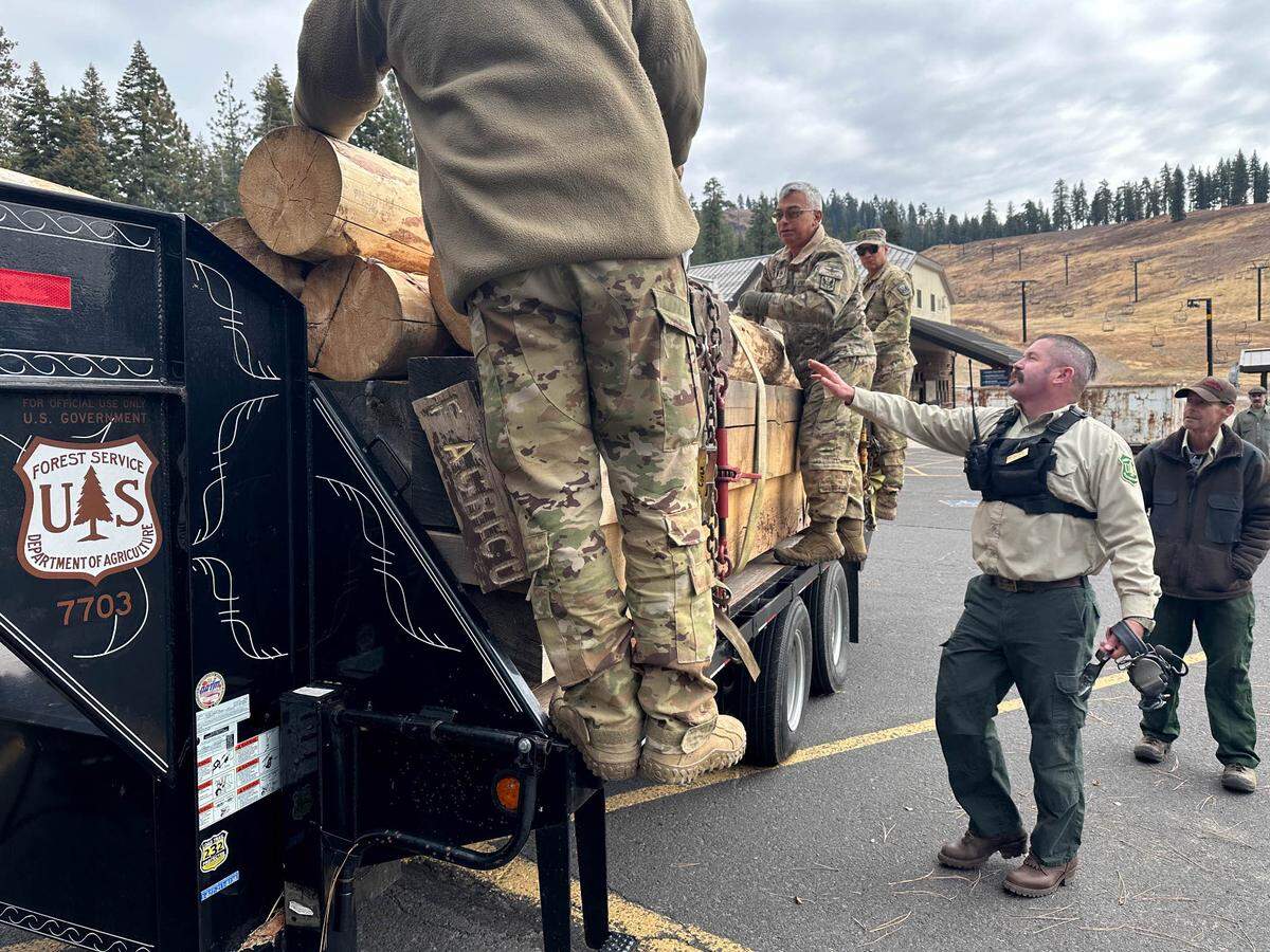 Soldiers with the California National Guard unload timber that will be used to conserve a cultural site, Oct. 30, 2024. The Stanislaus National Forest collaborated with the 1-126th Aviation, California National Guard to deliver critical supplies to remote areas of the forest near Cooper Meadow in the Emigrant Wilderness. (Courtesy photo)