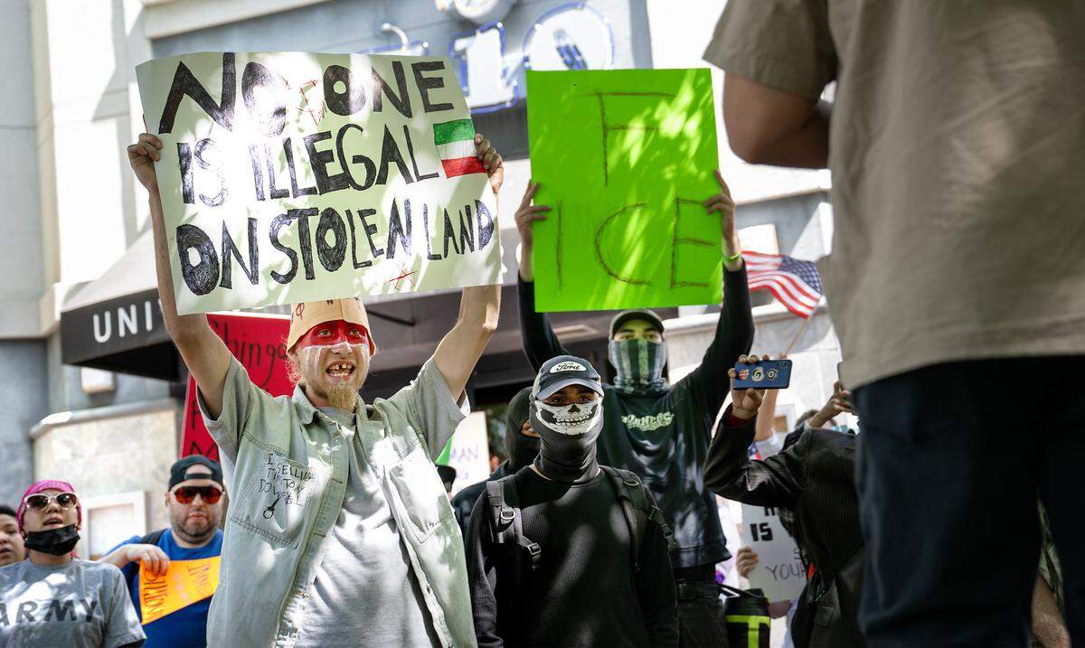 Protestors gathered at 10th Street Place to oppose Trump Administration policies in Modesto, Saturday, June 14, 2025. 