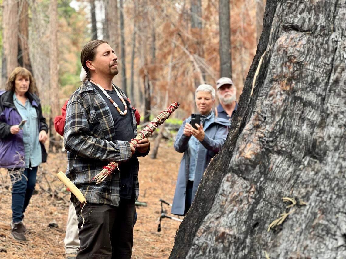 Adam Lewis, leader of the Calaveras band of Mi-Wuk Indians, sings Native songs and prays for The Orphans’ survival Sunday at Calaveras Big Trees State Park.