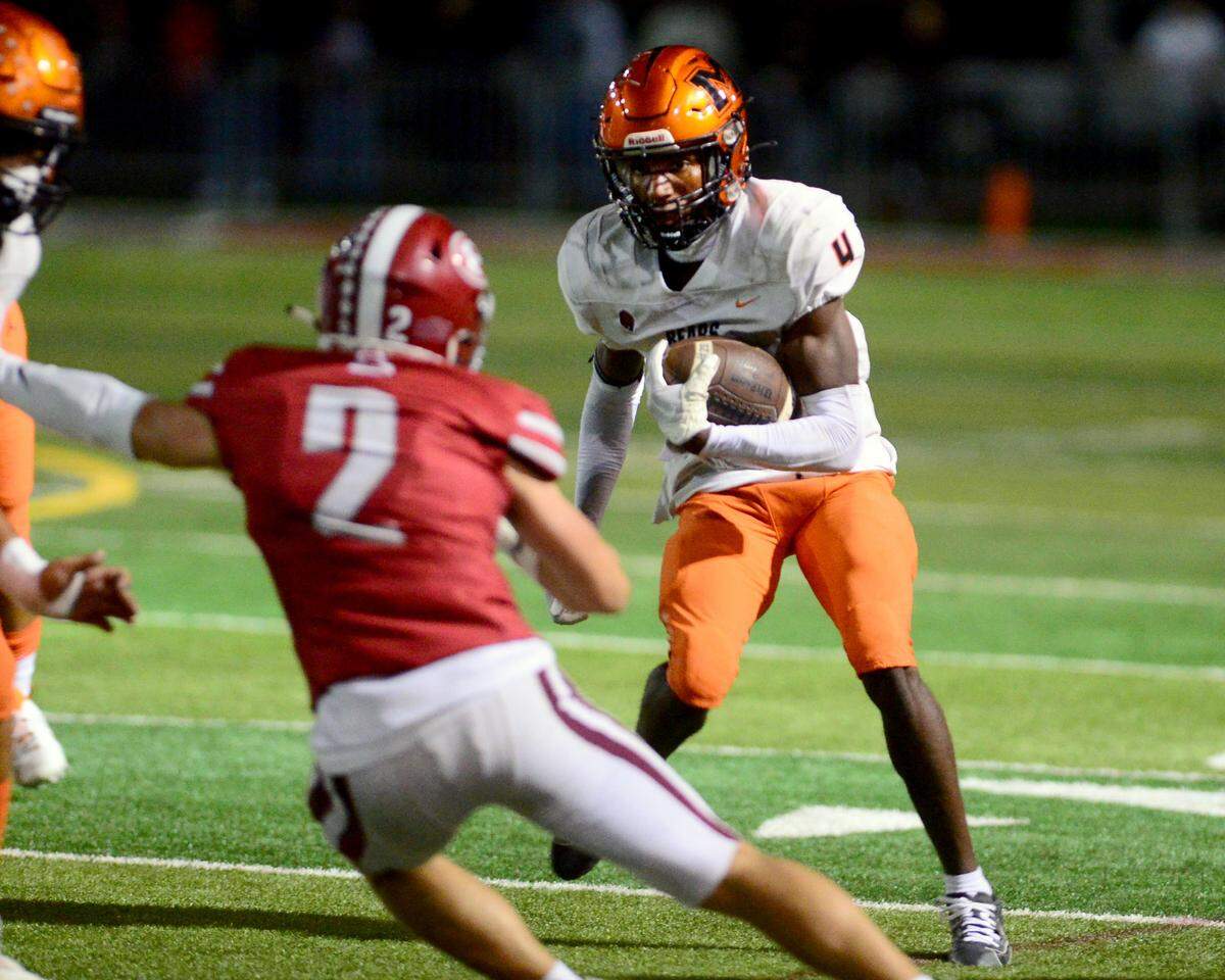 Merced running back Chase Smith (4) jukes a Patterson defender during a game between Patterson and Merced at Patterson High School in Patterson California on September 29, 2023.