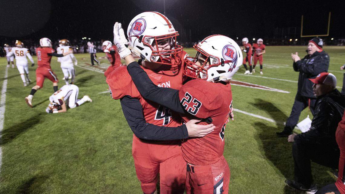 Ripon players Aaron Wood (4) and Danny Hernandez (23) celebrate their victory over Highland in the CIF State 4-AA championship game at ripon High School in Ripon, Calif., on Saturday, Dec. 14, 2019.