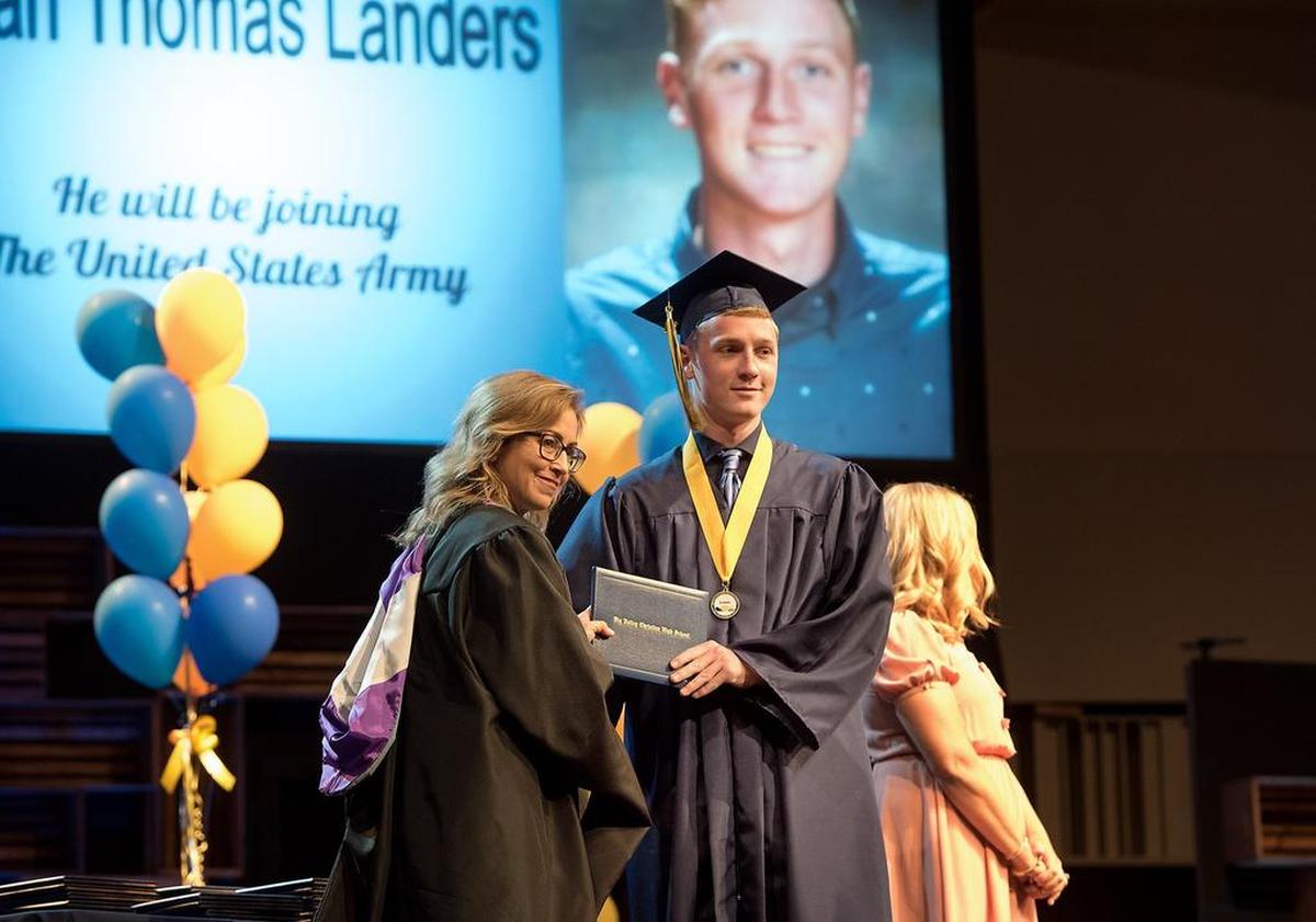 Ethan Landers receives his diploma from principal Michelle Mott during the Big Valley Christian School graduation ceremony at Big Valley Grace Community Church in Modesto, Calif., Friday, June 1, 2018. Landers will be joining the Army.