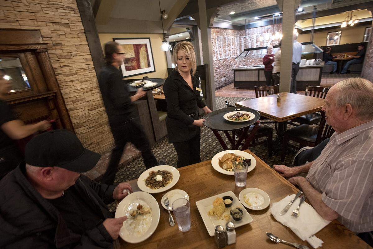 Server Sarah Cline, center, waits on guests at Marie Callendar’s Restaurant in Modesto, Calif., on Wednesday, Jan. 8, 2020.