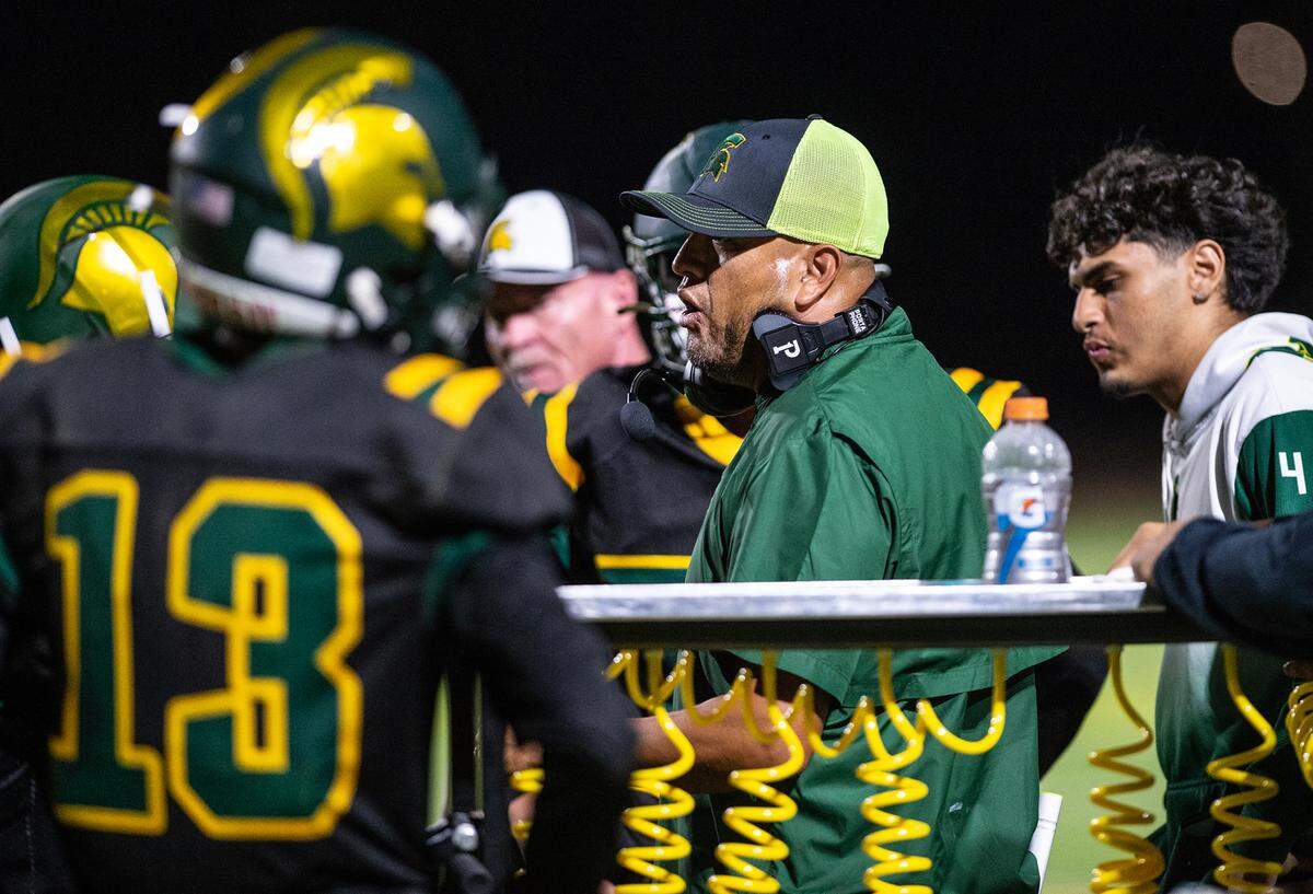 Davis head coach Tim Garcia talks to his players during a Western Athletic Conference game at Downey High School in Modesto, Calif., on Friday, September 23, 2022.