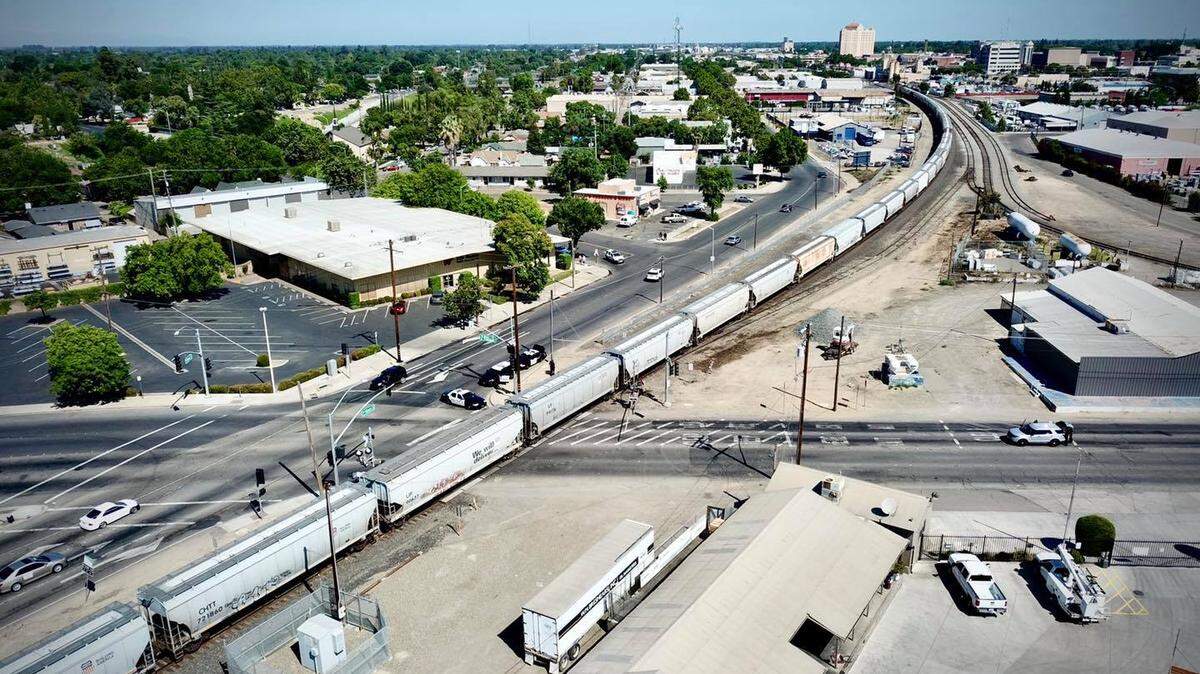 This photo from a Modesto Police Department drone shows officers investigating a fatal collision at the intersection of Seventh and B streets on Saturday morning involving a pedestrian and a train.