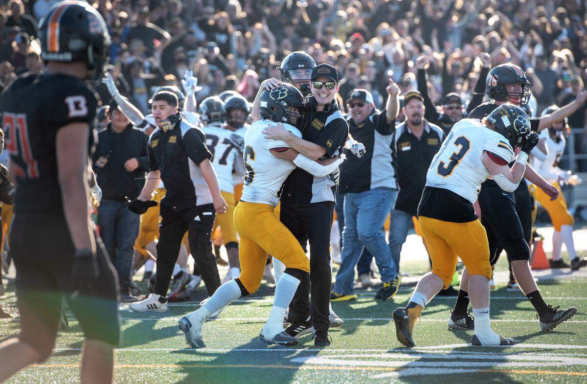 Hughson players and coaches celebrate a game-winning touchdown during the Sac-Joaquin Section Division VI championship game with Summerville at St. Mary’s High School in Stockton, Calif., Saturday, Nov. 26, 2022.