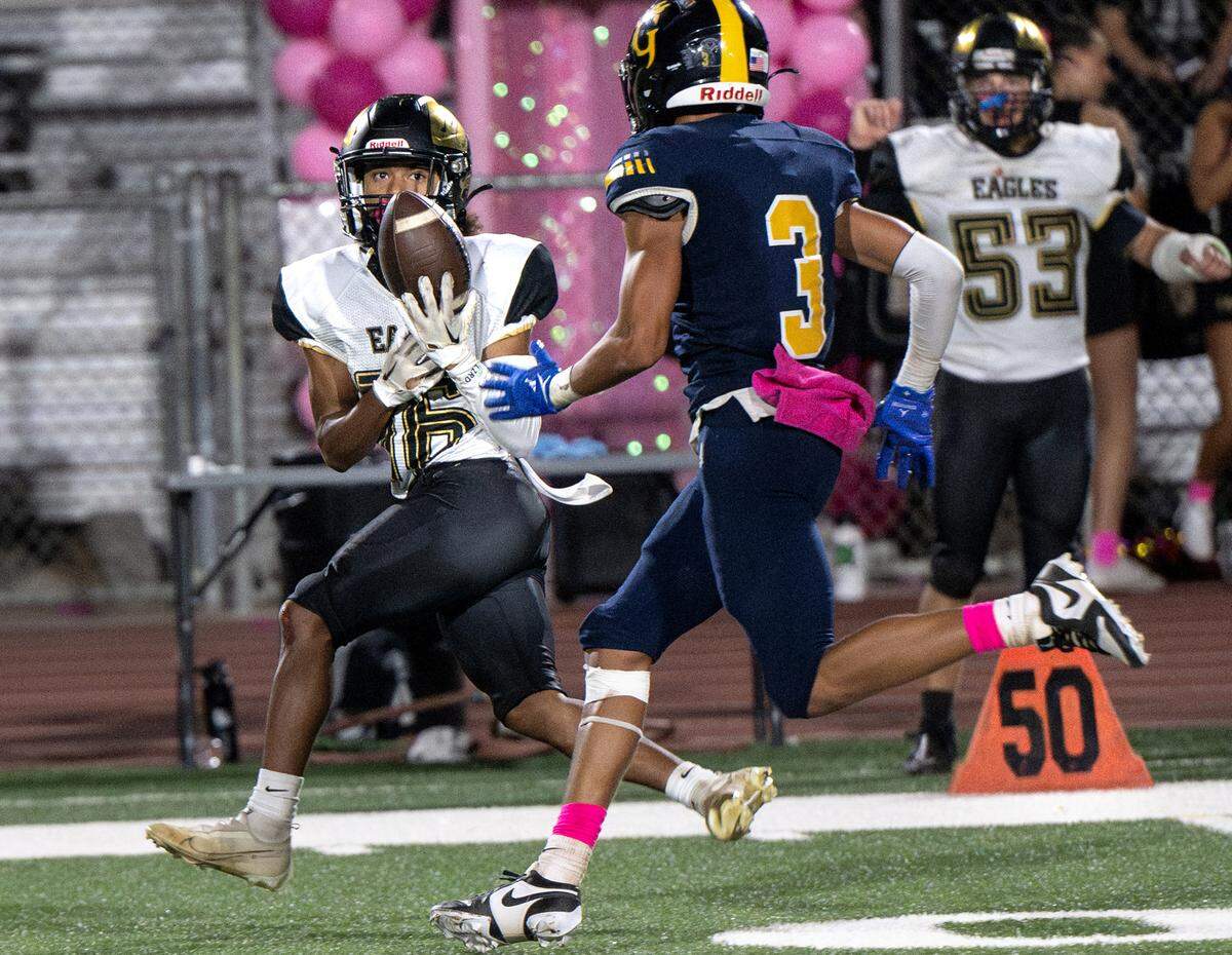Enochs’s Eric Myles makes a catch past Gregori defender Trey Webb during the Central California Athletic League game at Gregori High School in Modesto, Calif., Friday, Oct. 6, 2023.