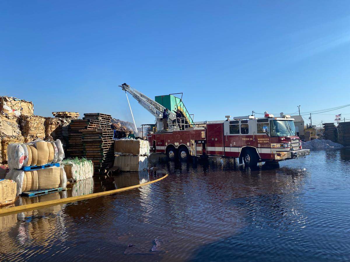 Firefighters spent Tuesday, Feb. 15, 2022, dousing smoldering piles of recycling materials at a facility on Morgan Road in south Modesto.