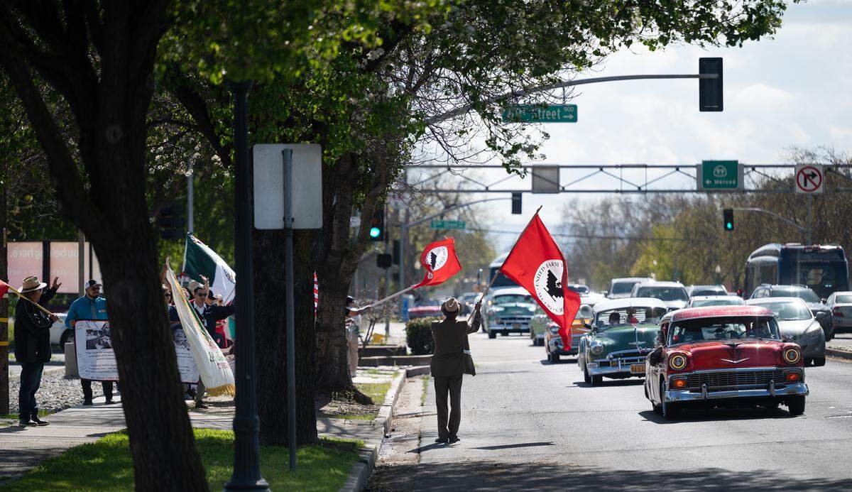 Sebastian Jones, middle, and others marched from Chavez Park to 10th Street plaza to commemorate the birthday of labor leader Cesar Chavez in Modesto, Calif., Friday, March 31, 2023.