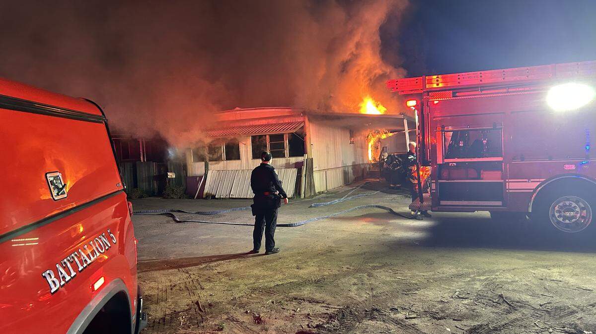 Firefighters battle a late-night mobile home fire in the 900 block of G Street in Oakdale. The occupant was airlifted with burns after attempting to rescue her pets, according to officials.