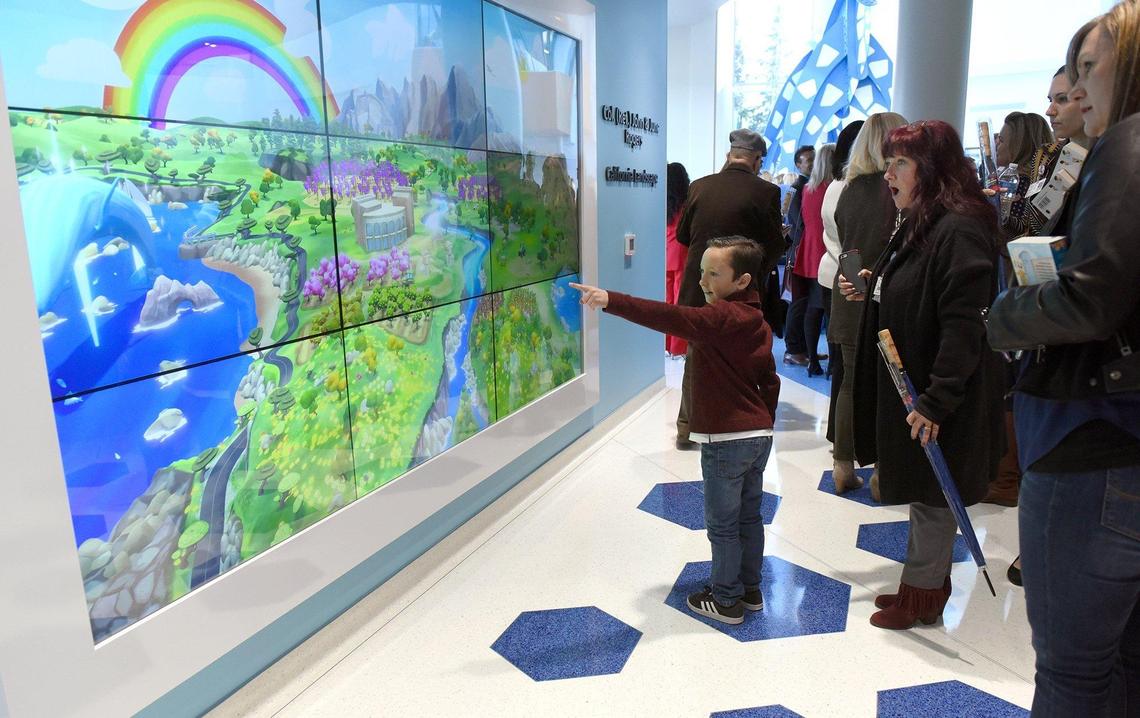 Mateo Garcia 7yrs, looks at an interactive mural-California Landscape at the Valley Children’s Pelandale Specialty Care Center during the grand opening Friday morning February 8, 2019 in Modesto, Calif. The 40,000 square foot state of the art medical facility will bring more pediatric specialists to the area including cardiology, neurology, gastroenterology and orthopaedics.