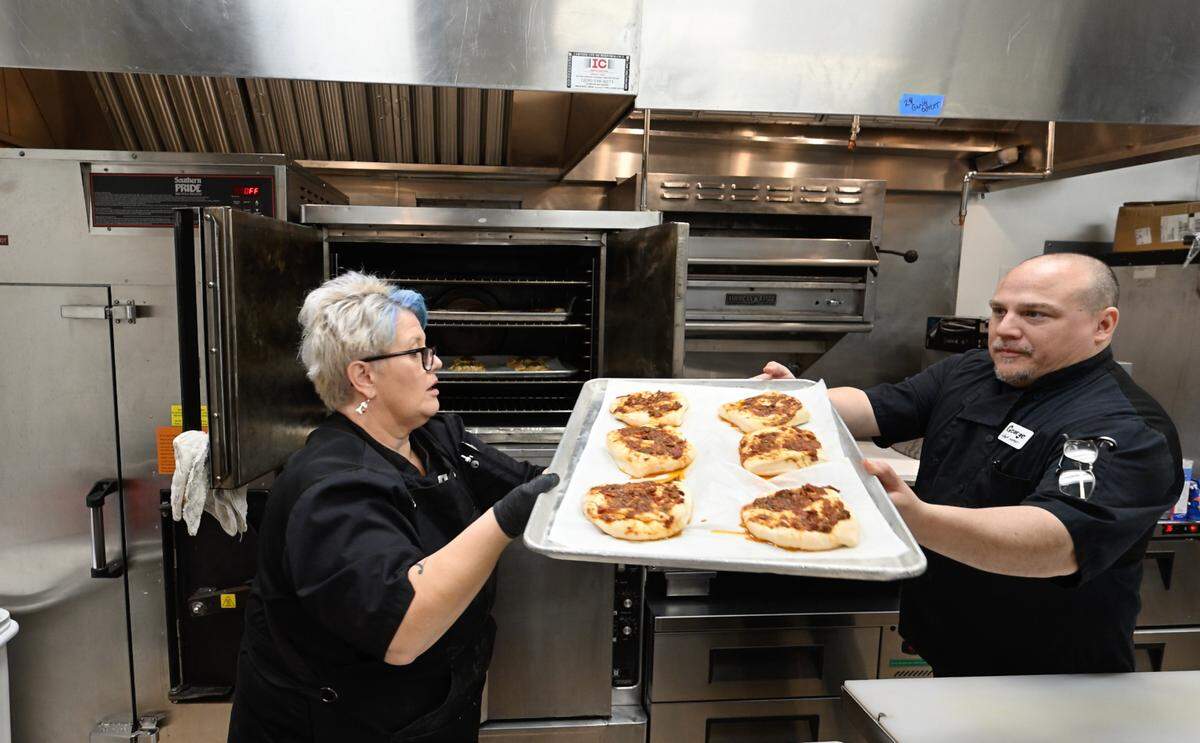 Chef/co-owner George Bertaina and sous chef Amber Romero put baked goods in the oven at Cora restaurant at Roseburg Square in Modesto, Calif., Friday, May 24, 2024.
