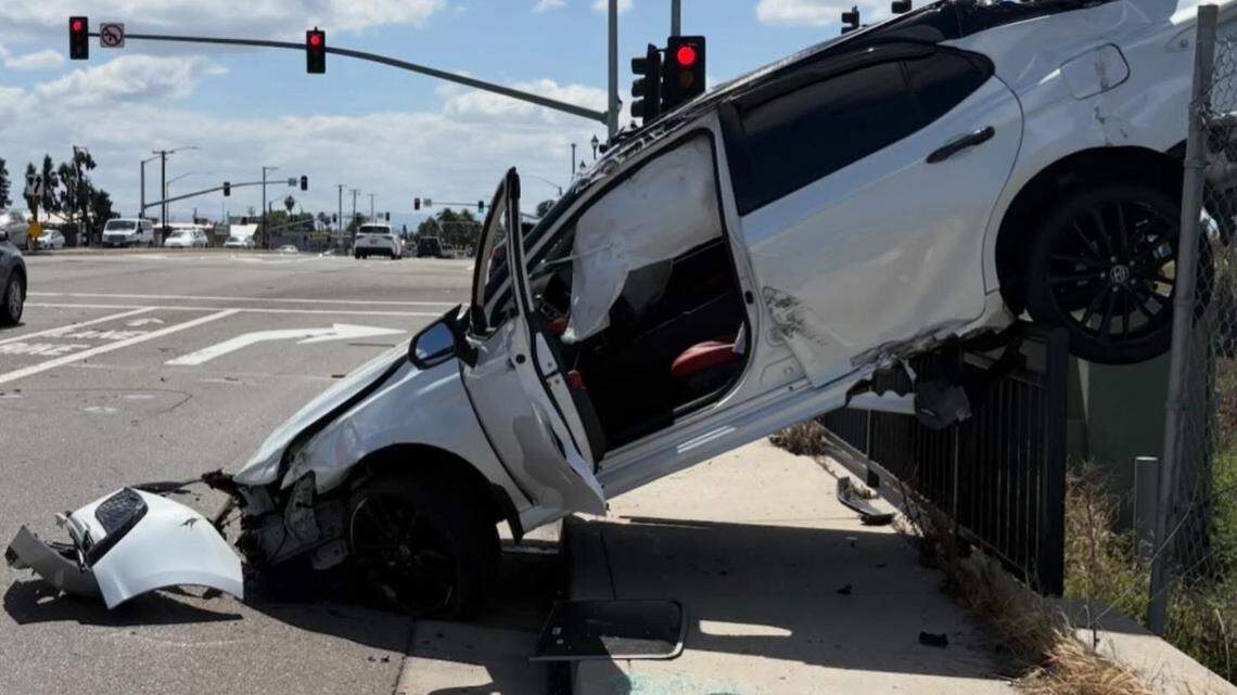 A Toyota Camry is seen overturned on a fence along Kiernan Avenue after the driver lost control while exiting Highway 99, leading to a collision with another vehicle, CHP said.