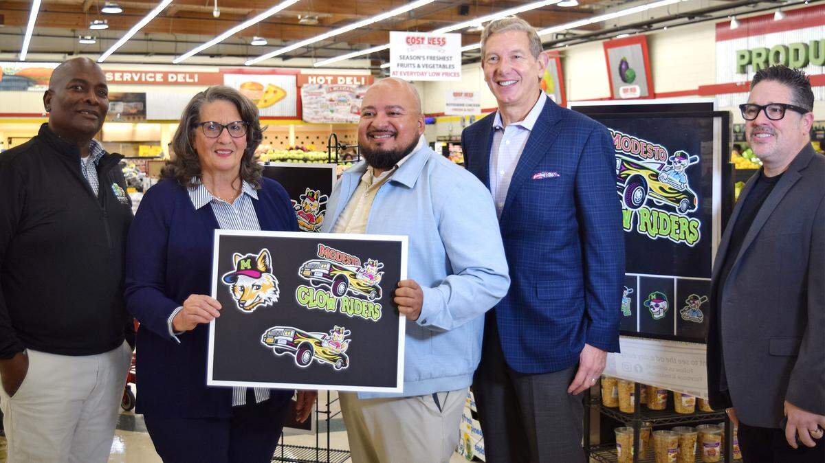 Modesto City Councilmember Jeremiah Williams, Modesto Mayor Sue Zwahlen, Ceres Mayor Javier Lopez, Modesto Glow Riders owner David Heller and Modesto City Councilmember Chris Ricci pose with team logos at a press conference announcing the new Pioneer Baseball League team in Ceres, Monday, Nov. 10, 2025.