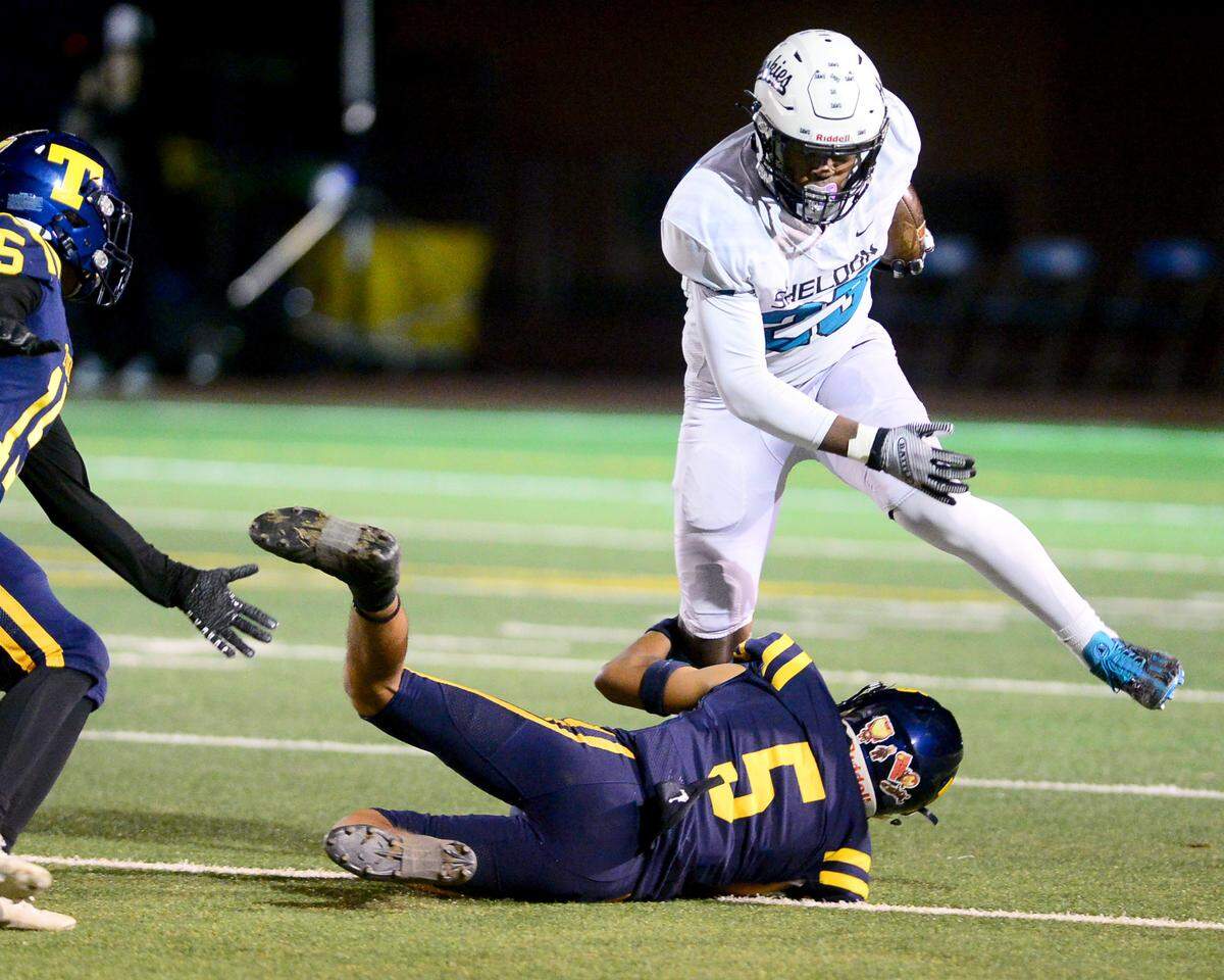Sheldon running back Zayden Learson (23) runs over a Turlock defender during a CIF Sac-Joaquin Section Football Division I playoff game between Turlock High School and Sheldon High School at Turlock High School in Turlock, California on Nov. 3, 2023.