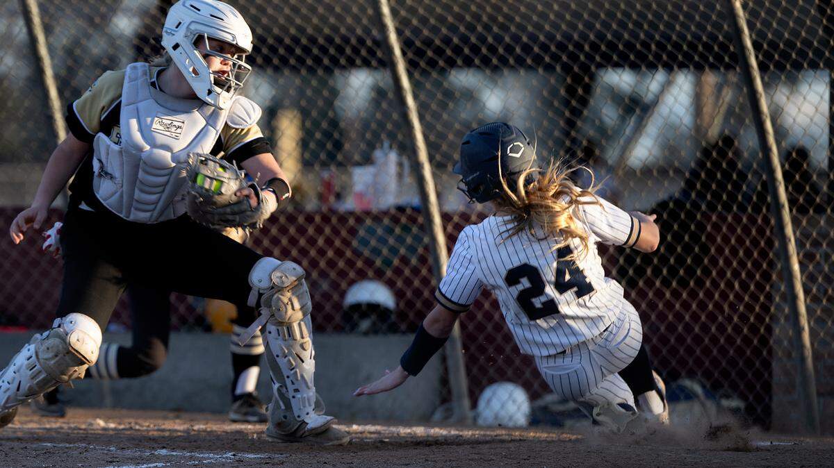 Central Catholic’s Emori Machado beats the throw home to score the winning run during the game with Enochs at Rainbow Fields in Modesto, Calif., Tuesday, March 5, 2024.