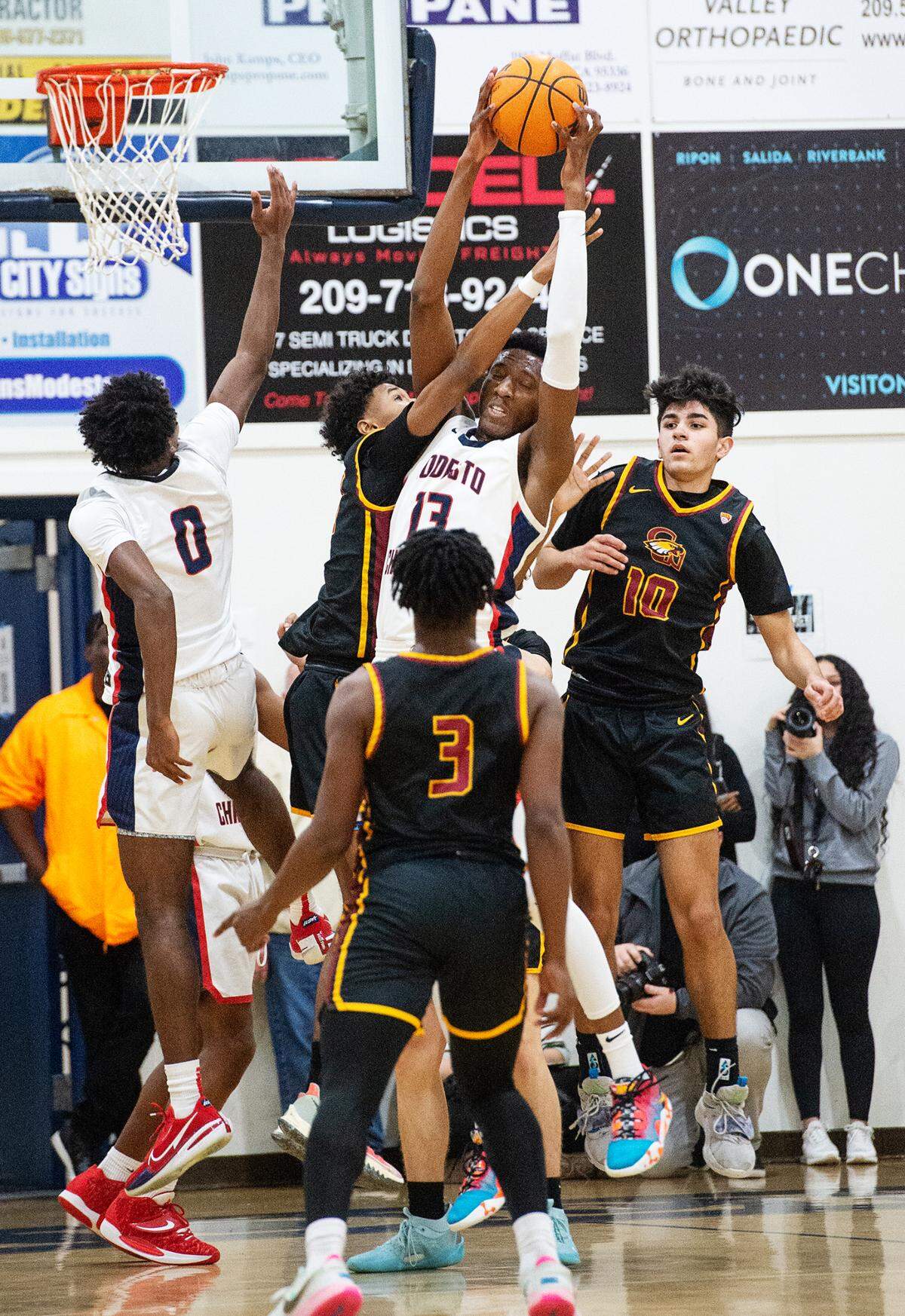 Modesto Christian’s Prince Oseya grabs a rebound during the Modesto Christian Holiday Hoop Classic championship game with Clovis West at Modesto Christian High School in Salida, Calif., Friday, Dec. 30, 2022.
