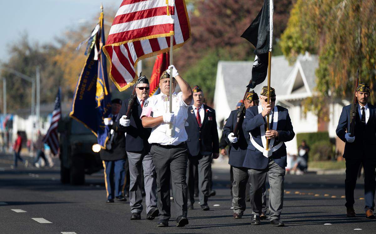 A color guard leads the Modesto Veterans Day Parade in Modesto, Calif., Saturday, Nov. 11, 2023.