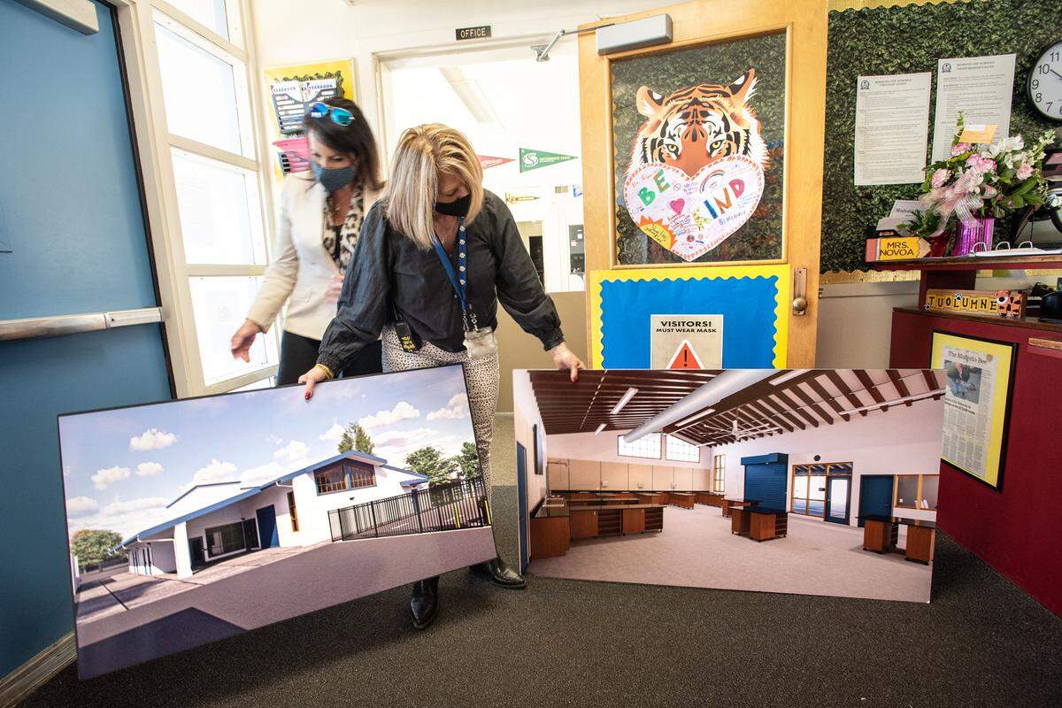 Principal Lisa Frymire, shows enlargements of architectural renderings of the school’s furture STEM building that is under construction at Tuolumne Elementary School in Modesto, Calif., on Thursday, Feb.17, 2022.