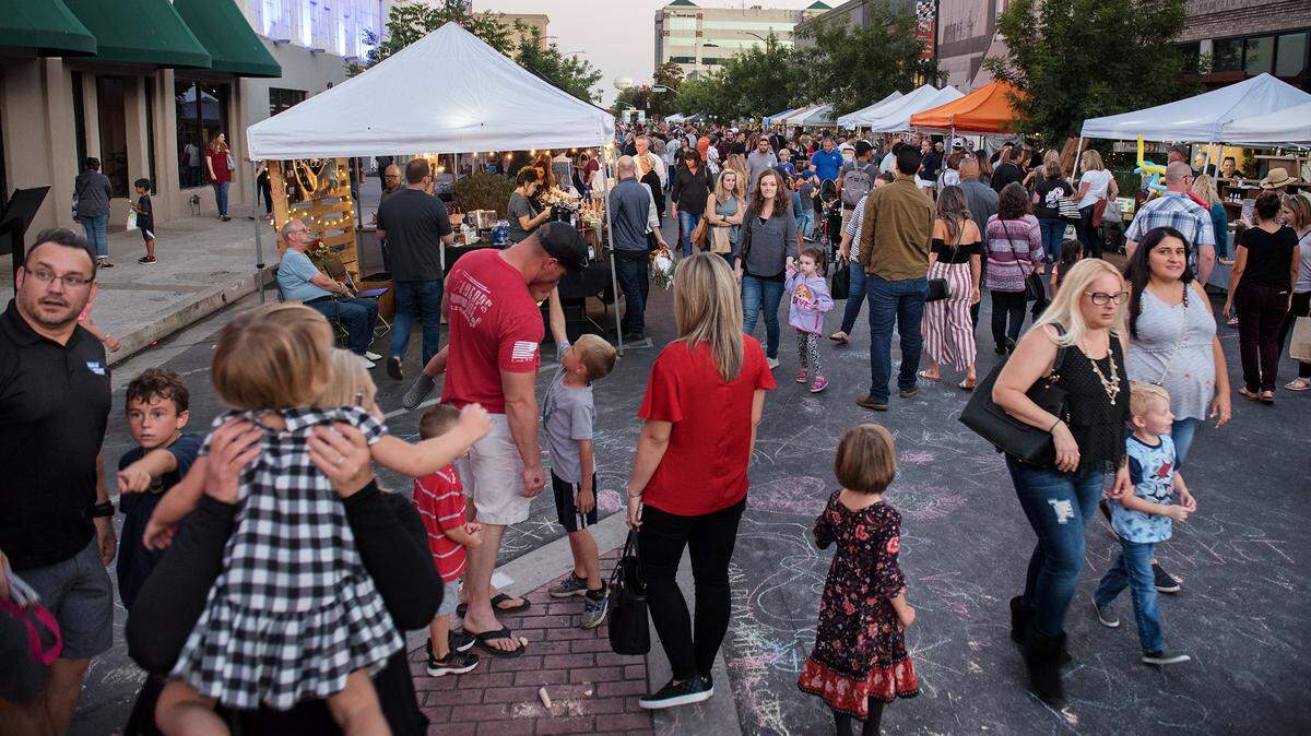 People shop, enjoy music and other entertainment on 10th Street during the DoMo First Fridays market in Modesto, Calif. on Oct. 5, 2018.