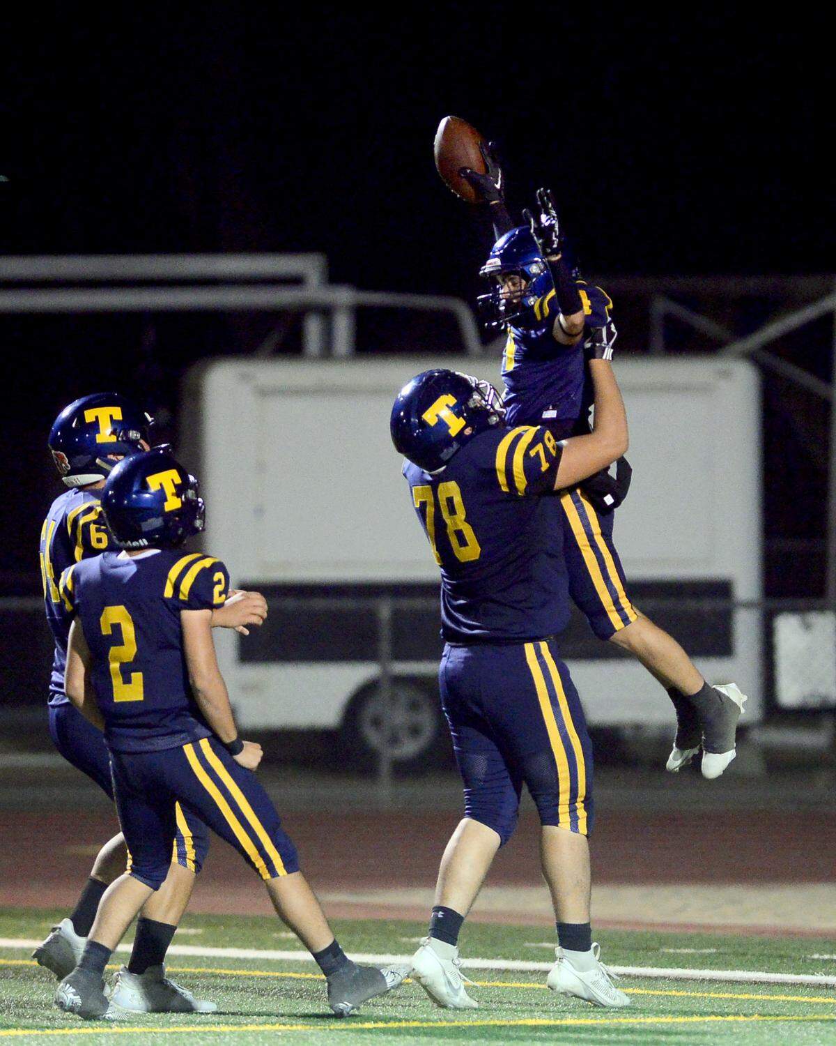 Turlock running back Jr. Silva (4) celebrates scoring a touchdown with teammate Kristian Gurrero (78) during a CIF Sac-Joaquin Section Football Division I playoff game between Turlock High School and Sheldon High School at Turlock High School in Turlock, California on Nov. 3, 2023.