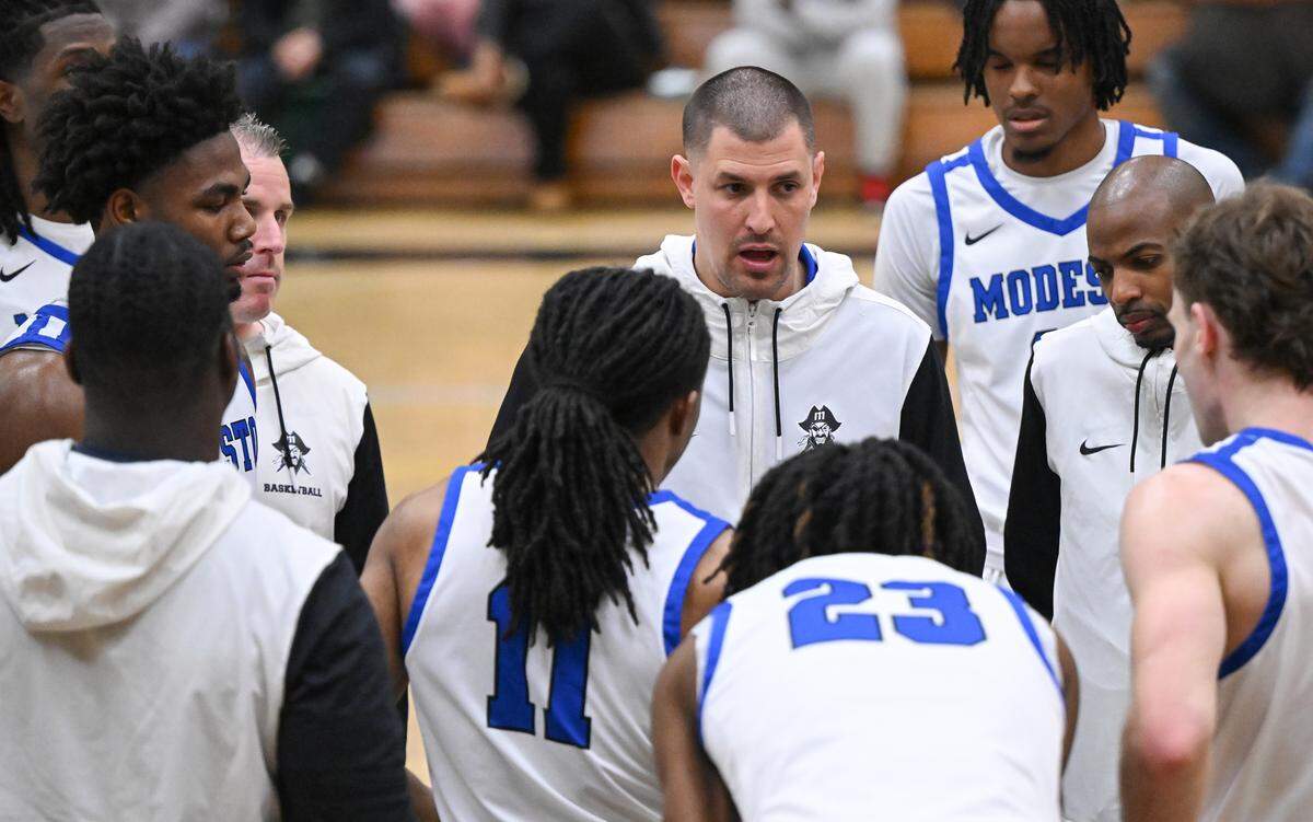 Modesto head coach Brice Fantazia talks with his players during a timeout in the Big 8 Conference game with American River College at Modesto Junior College in Modesto, Thursday, Feb. 13, 2025.
