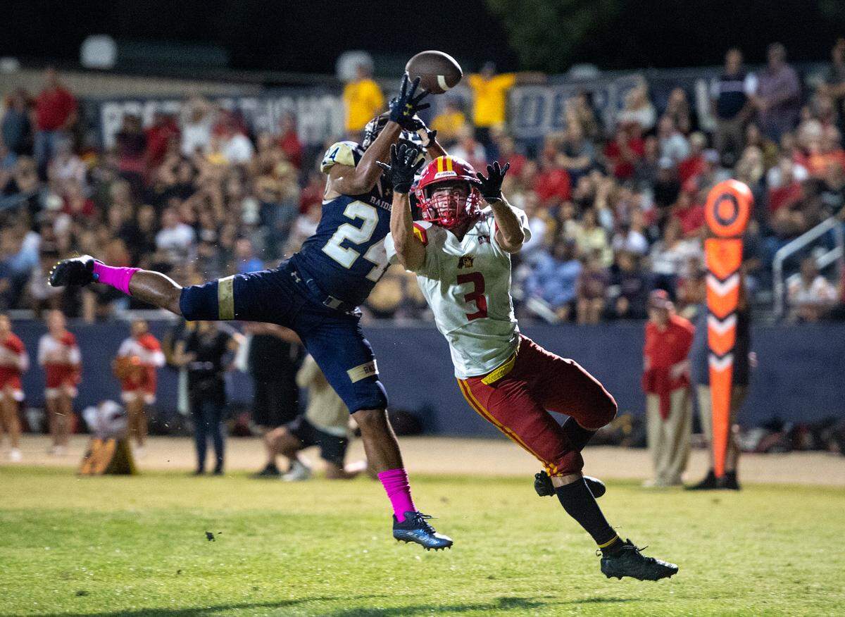 Central Catholic’s Roland Brown breaks up a pass to Oakdale’s Jace Rau during the Valley Oak League game with Oakdale in Modesto, Calif., Friday, Oct. 14, 2022. Central Catholic won the game 35-7.