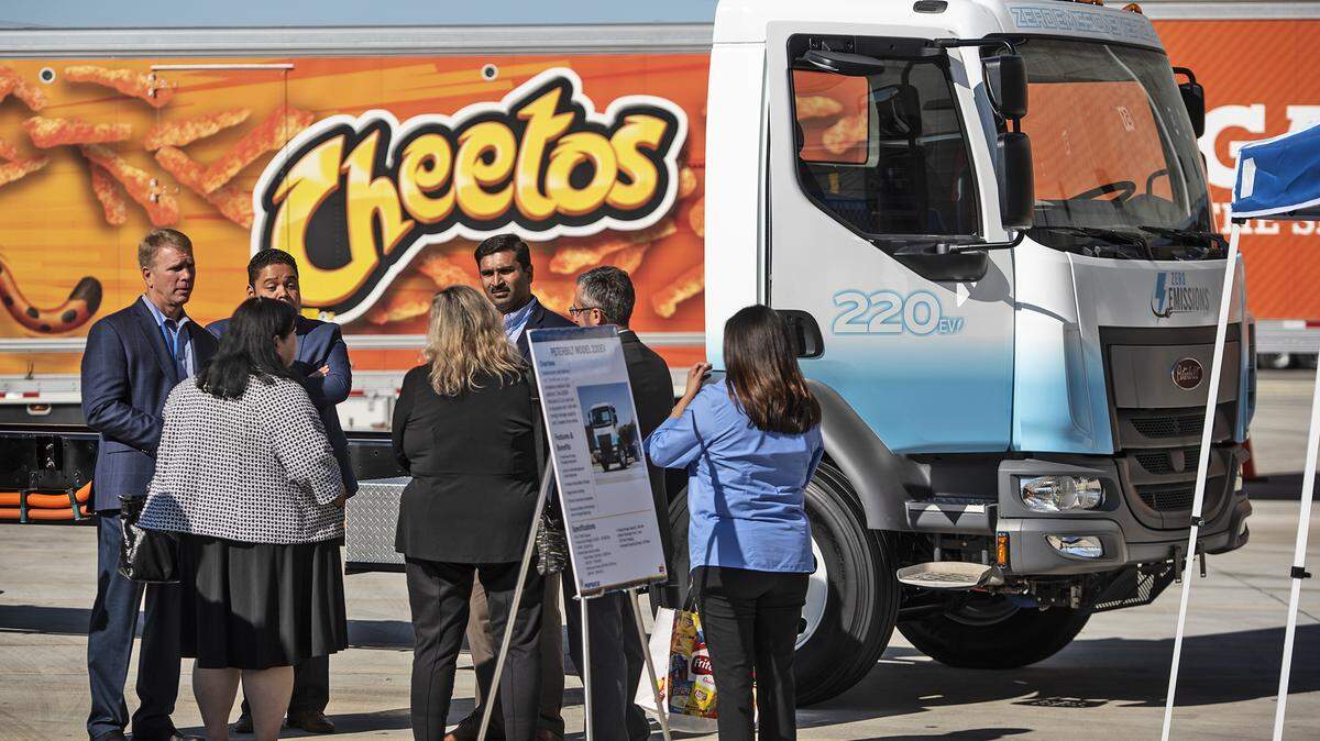Visitors look at the electric box truck at the Frito Lay plant where the company announced that it will use an entirely sustainable fleet of vehicles at their Modesto plant in Modesto, Calif., Thursday, Oct. 3 , 2019. The Modesto plant will use electric Tesla semi trucks and other production vehicles as part of a $30 million project to convert its entire diesel fleet to sustainable vehicles.