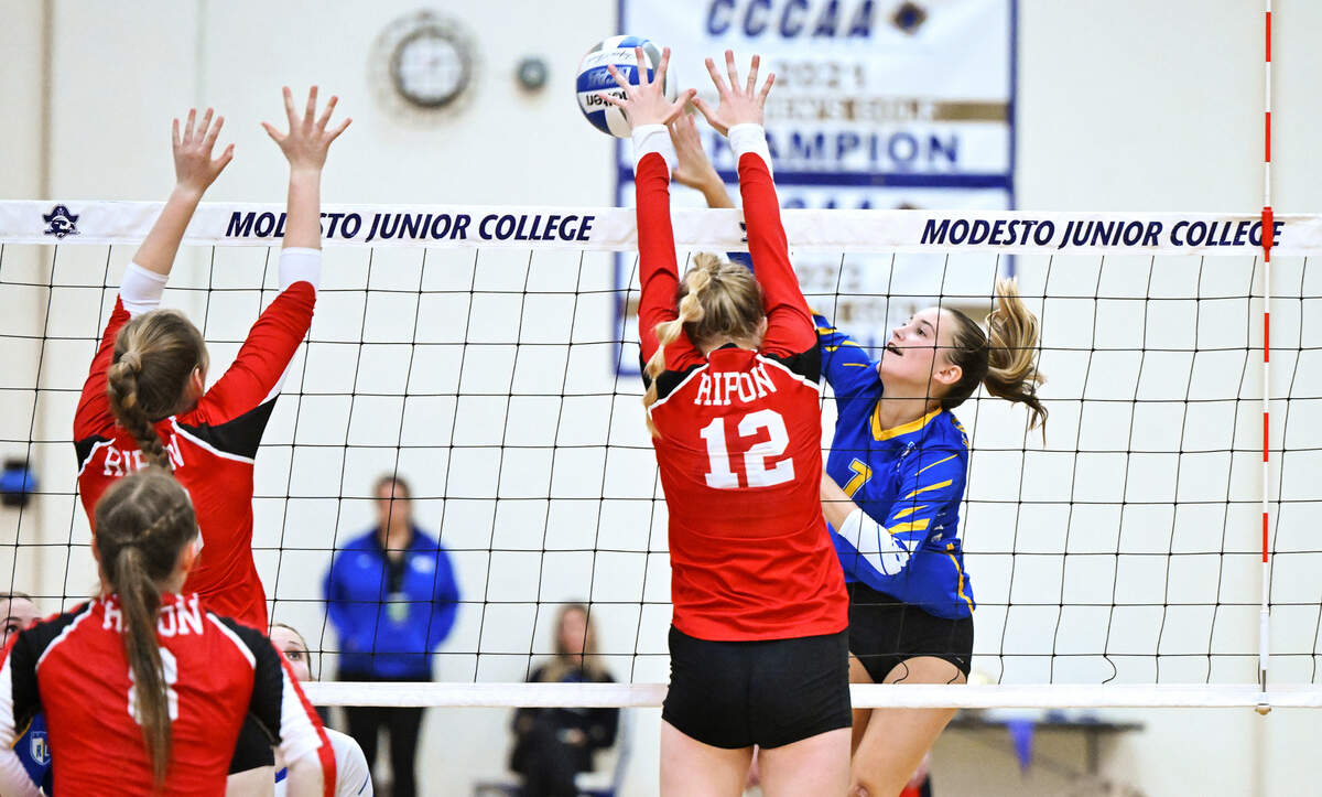 Ripon Christian’s Jordan Vander Veen spikes the ball past Ripon’s Katherine Eskes (12) during the Sac-Joaquin Section Division IV championship match at Modesto Junior College in Modesto, Calif., Saturday, Nov. 4, 2023. Ripon Christian won the match 3-0.