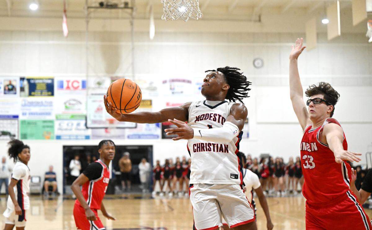 Modesto Christian’s Jeremiah Bernard scores on a reverse layup past Lincoln’s Dilan Fanucchi during the Tri-City Athletic League game at Modesto Christian High School in Salida, Calif., Friday, Jan. 12, 2024.