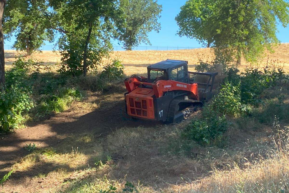 Vegetation is bulldozed as a fire-prevention method in Modesto’s Tuolumne River Regional Park.