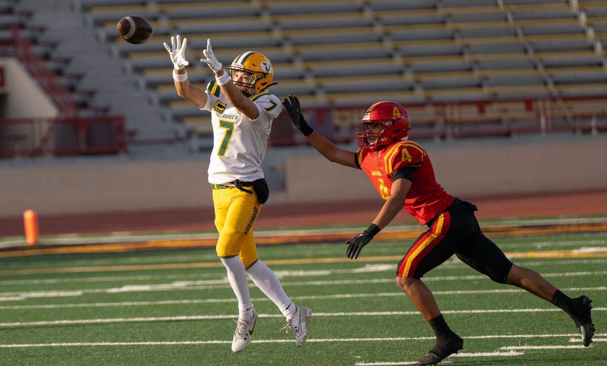 Vanden’s Logan Bailey makes a catch in front of coverage from Oakdale’s Gavin Wyatt in the Sac-Joaquin Section Division 3 championship game at Sacramento City College in Sacramento, Saturday, Nov. 30, 2024. Bailey finished the game with 14 catches for 235 yards and three touchdowns.