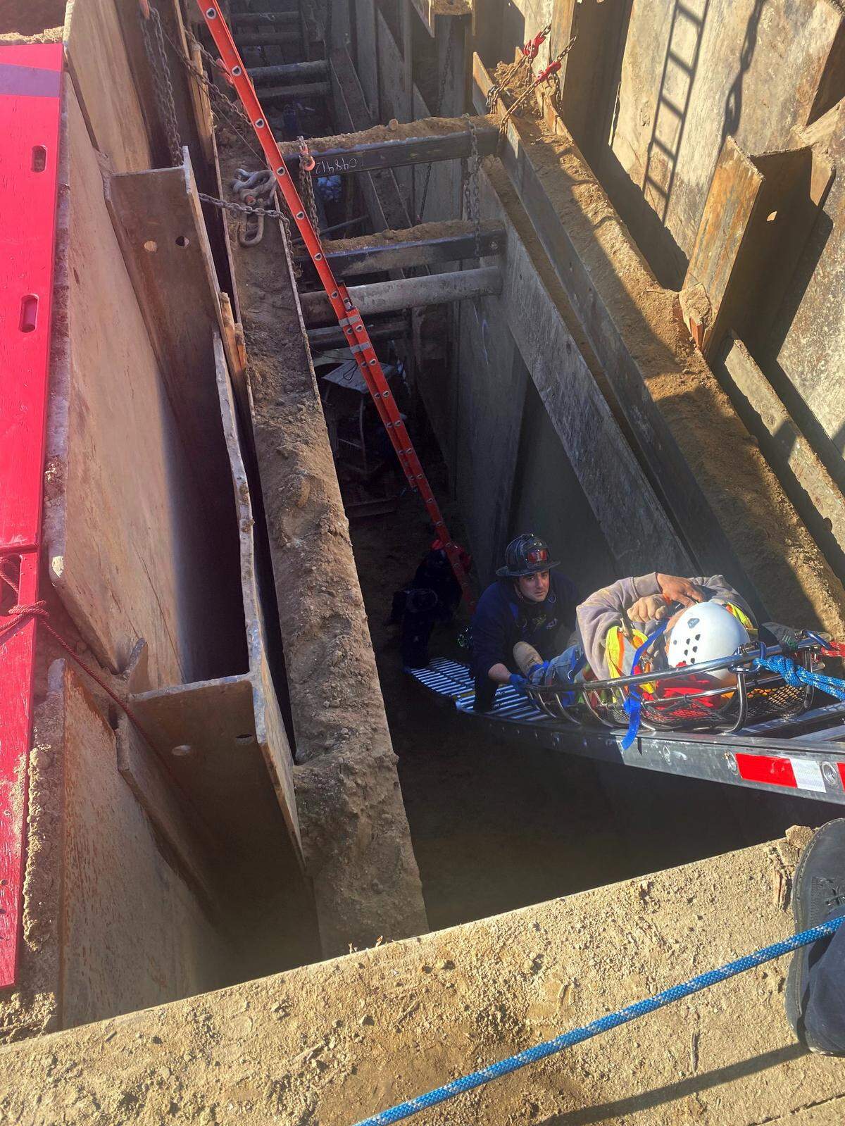 Modesto firefighters rescue a man who fell nearly 30 feet behind a metal plate holding a trench together where a construction crew is installing sewer pipes.