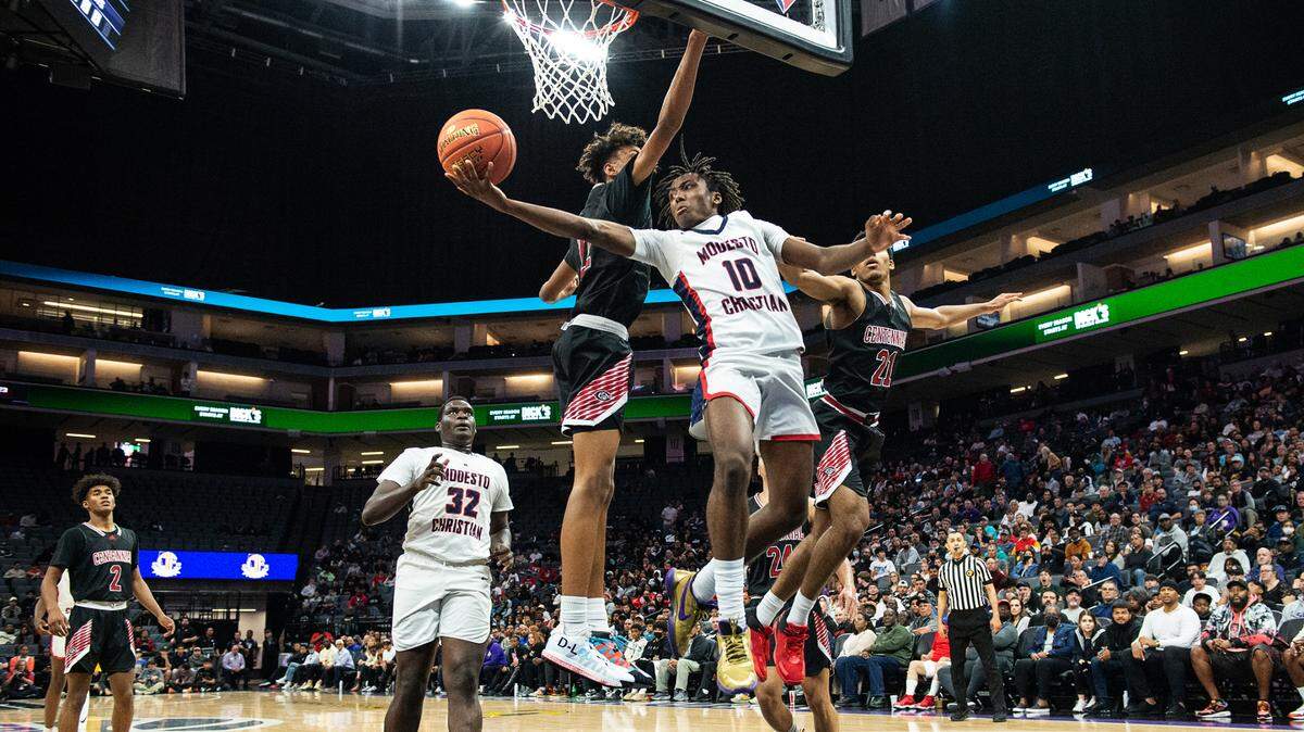 Modesto Christian’s BJ Davis fakes a layup and passes the ball during the boys Open Division CIF State Basketball Championship game with Centennial at Golden 1 Center in Sacramento, Calif., on Saturday, March 12, 2022. Centennial won the game 59-50.