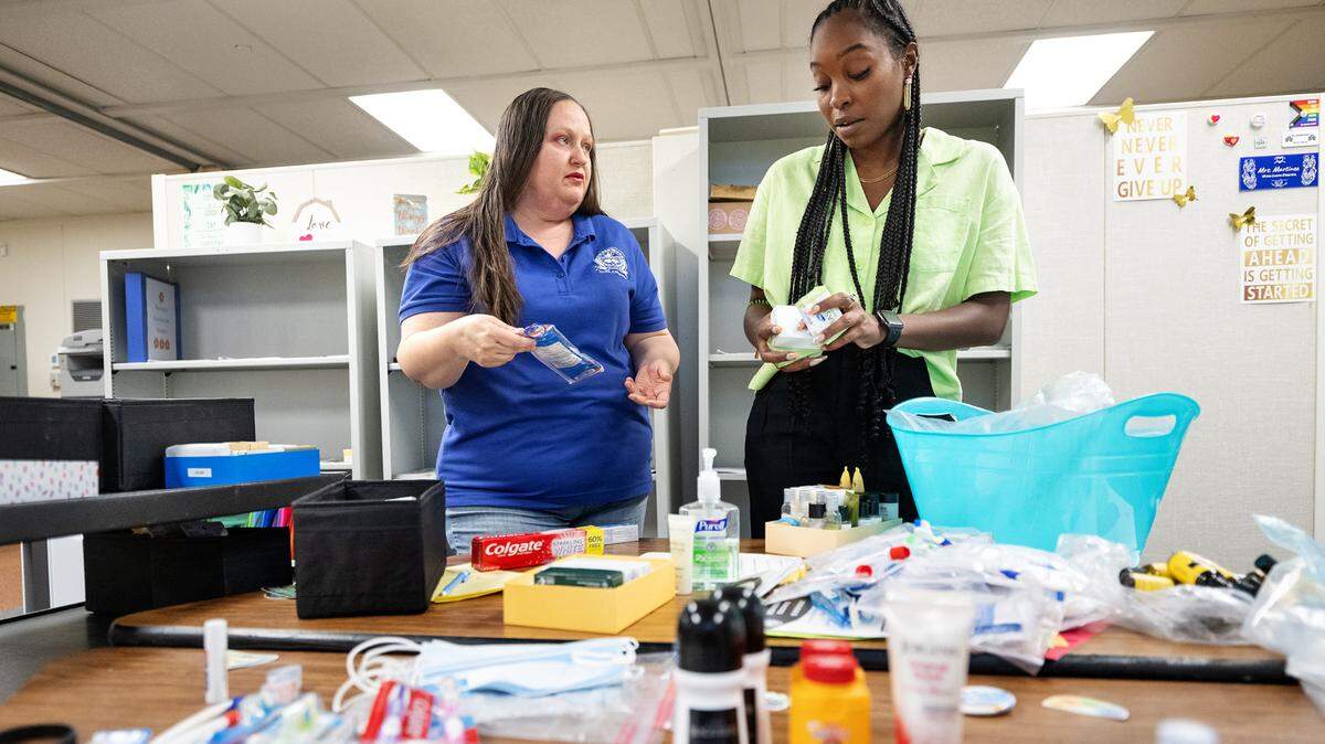 Parent Ambassador Hope Lyons, left, and Community Schools Coordinator Brittany Collins, right, sort through toiletries in the community center at Elliott Alternative school in Modesto, Calif., Wednesday, Aug. 14, 2024. Parent and students are offered personal hygiene products and other family services at the community center on campus.