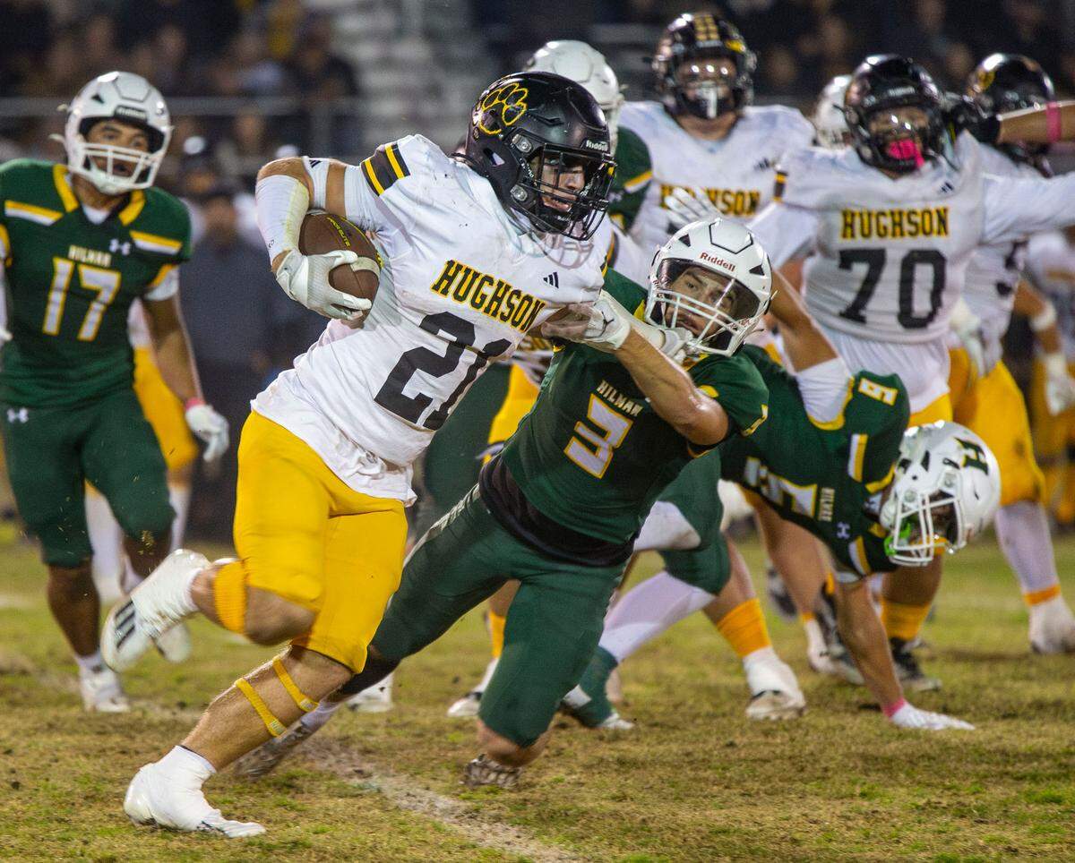 Eli Wilbanks, 21, of Hughson High School tries to work his way around Tanner Westmoreland, 3, of Hilmar High during the Trans-Valley League game against Hilmar in Hilmar, Calif. on Friday Oct. 25, 2024.
