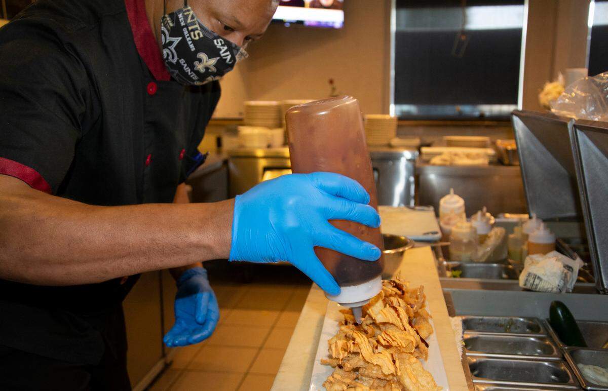 Chef/co-owner David Patterson prepares poke nachos at his new restaurant Midtown Bistro Jan. 15, 2021 in Modesto, Calif.