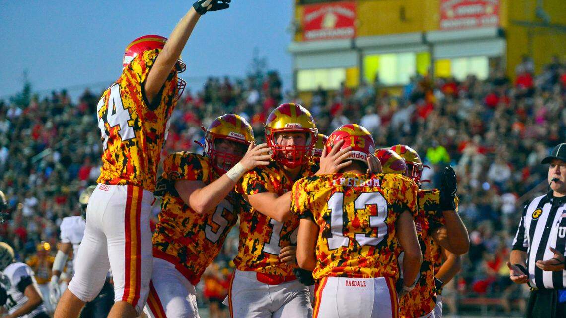 Oakdale teammates celebrate with Kevin Camelin (13) after scoring a touchdown during a football game between Oakdale High School and Archbishop Mitty High School at Oakdale High School in Oakdale California on September 10, 2021.