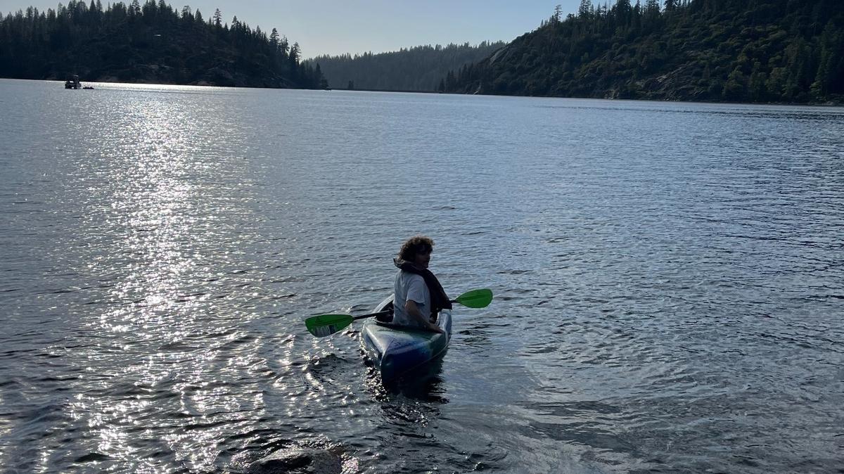 A kayaker wears a life jacket on Pinecrest Lake in Tuolumne County on Monday, June 10, 2024.