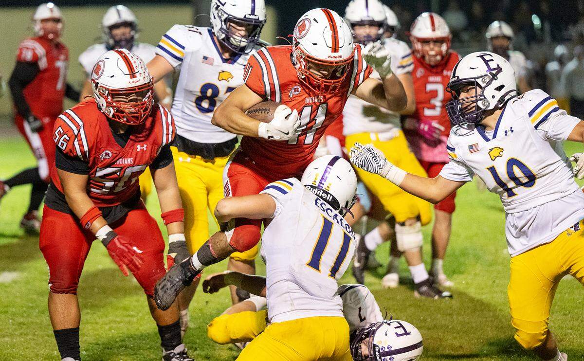 Ripon’s Eric Guevara is stopped by Escalon defenders during the Trans-Valley League game at Ripon High School in Ripon, Friday, Oct. 25, 2024.