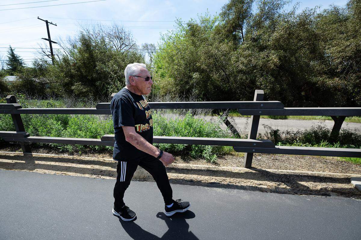 John Scheuber, 84, walks on the Virginia Trail in Modesto, Calif., Wednesday, April 10, 2024. Scheuber completed a goal set 11 years ago of walking the circumference of the earth, or 24,901 miles.