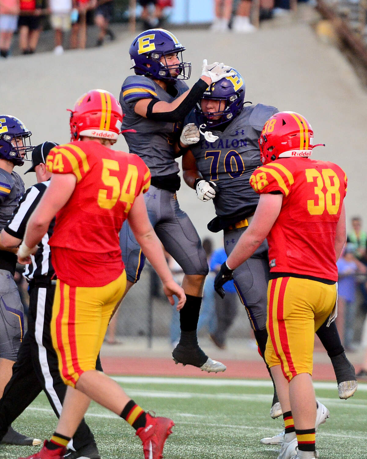 Escalons Sam Jimenez (5) and Gio Chavez (70) celebrate a touchdown during a game between Oakdale and Escalon at Oakdale High School in Oakdale, California, on September 15, 2023.