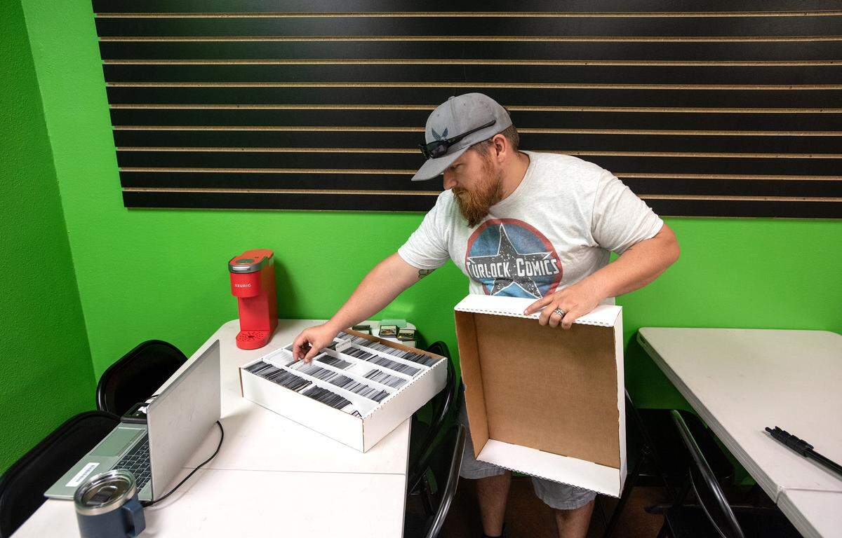 Owner Kyle Turner shows sorted magic cards in the game room at Turlock Comics in Turlock, Calif., on Wednesday, June, 15, 2022.