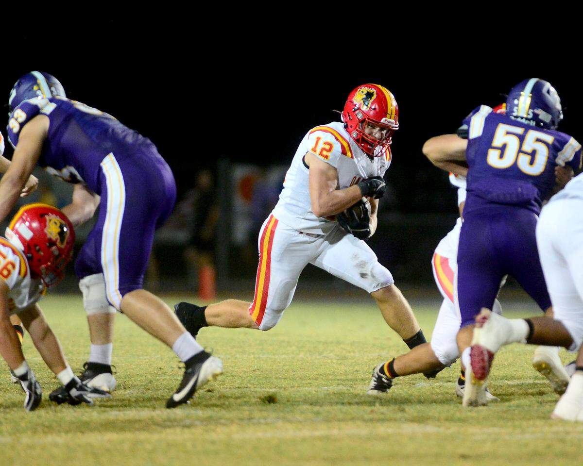 Oakdale’s Wes Burford (12) cuts up field during a game between Escalon High School and Oakdale High School in Escalon, Calif. on Sept. 6, 2024. Oakdale won the game 21-20 in overtime.