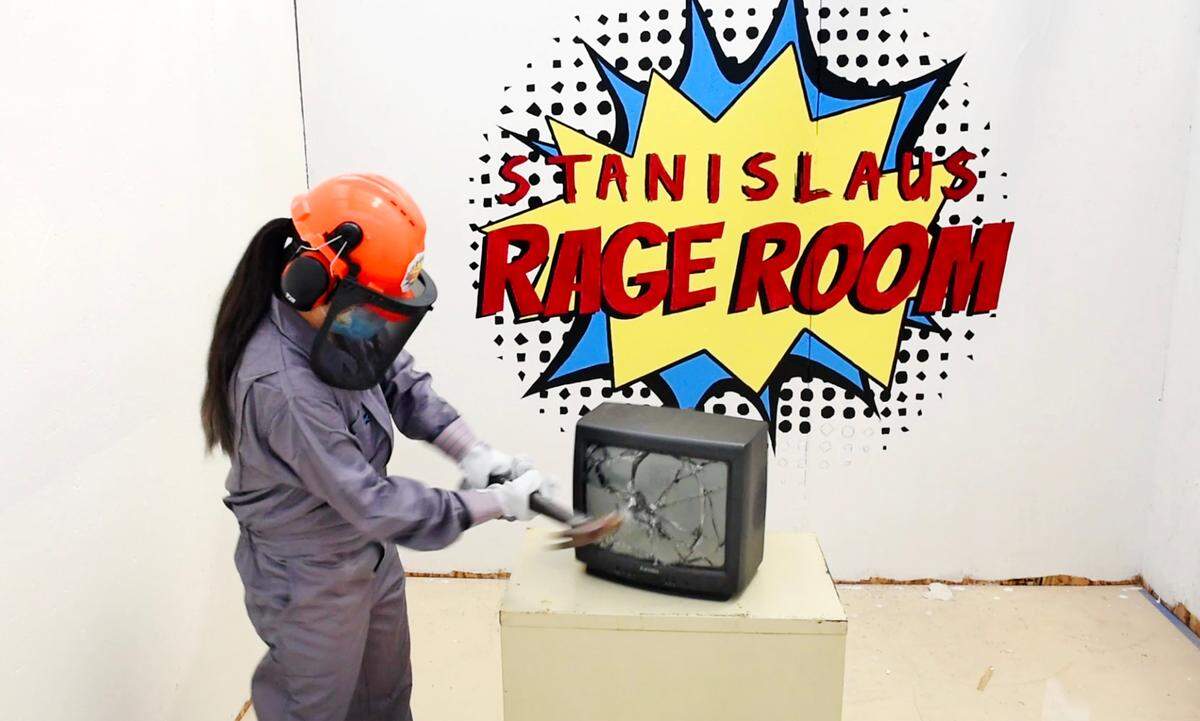Modesto Bee reporter Marijke Rowland destroys a TV monitor at the Stanislaus Rage Room in Salida, Calif., on Friday, July 31, 2020.