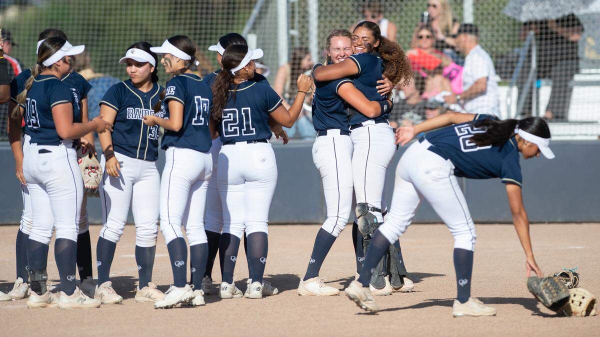 Central Catholic pitcher Randi Roelling and catcher Madison Harrison hug, right, as they celebrate a 6-0 shutout of Oakdale with their teammates after the Valley Oak League game at Central Catholic High School in Modesto, Calif., Tuesday, April 25, 2023.